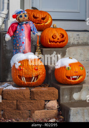 Decorated and carved pumpkins for Halloween placed on front porch of suburban home, Castle Rock Colorado US. Photo taken Oct. 31, 2018 Stock Photo