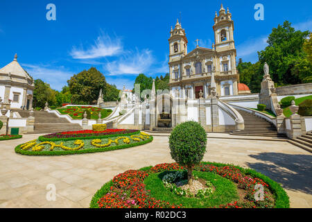 facade of the Bom Jesus do Monte Sanctuary in neoclassical style surrounded by flowered gardens in a sunny day. Tenoes near Braga, north of Portugal, Europe. Stock Photo