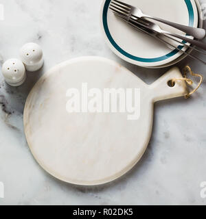 empty marble cutting board on a marble table. copy space Stock Photo