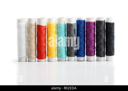 Blue thread. Set of sewing thread coils on white natural fabric
