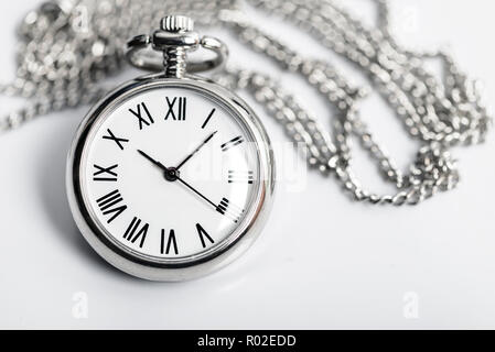 Retro styled pocket watch on the background of a light gray Stock Photo