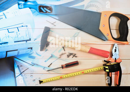 Assorted work tools and home design blueprints collage Stock Photo