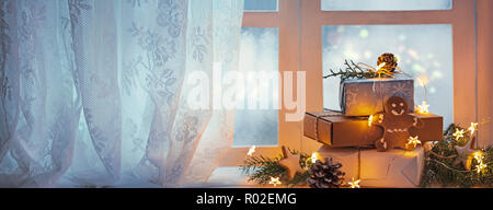 Merry Christmas and happy holidays Window with gift boxes and lights,new year decoration. Stock Photo