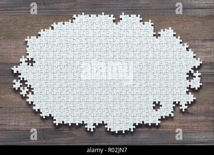 Blank jigsaw puzzle missing pieces to finish. Concept of work not completed. Stock Photo