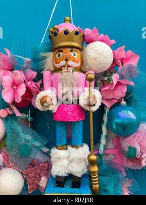 New Year's wreath with a figure of a nutcrack hanging on a wooden door Stock Photo