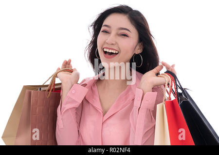 cheerful young woman holding shopping bag isolated on a white background Stock Photo