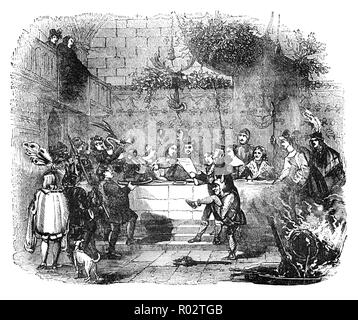 The Boar's Head Feast originated at Queen's College, Oxford, England in 1340. Legend has it that a scholar was studying a book of Aristotle while walking through the forest on his way to Christmas Mass. Suddenly confronted by an angry wild boar. and aving no other weapon, the resourceful Oxonian rammed his metal-bound book down the throat of the charging animal, choking the brute to death. That night the boar's head, dressed and garnished, was borne in procession to the dining room. Like the Yule log festival it became a medieval English Christmas tradition Stock Photo