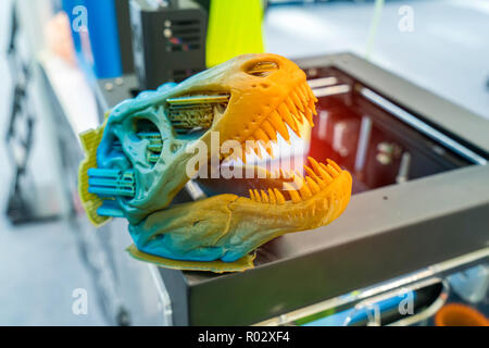 3D printer printing dragon head figure close-up. Stock Photo