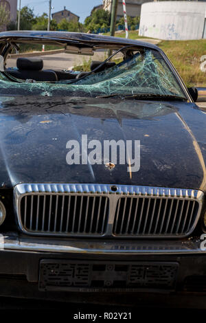 Front view Abandon on the street Rusty Daimler Six/Jaguar XJR with Broken Windshield Stock Photo