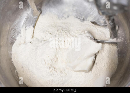 Close up of dough in electric bakery mixer Stock Photo