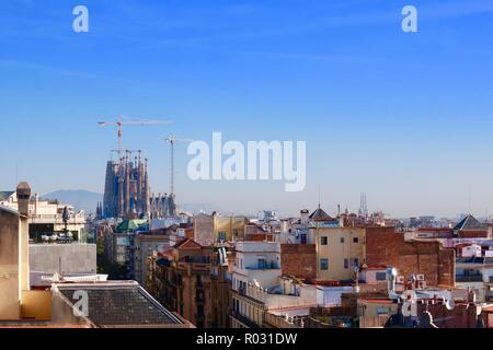 Barcelona, Spain, October 2018. View from the roof of Gaudi’s Casa Mila also known as La Pedrera. The Sagrada Familia is visible in the distance. Stock Photo