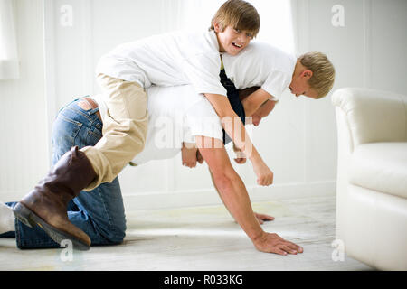 Father having fun while playing with his two young sons. Stock Photo