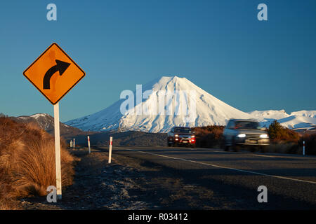 Mt Ngauruhoe and traffic on Desert Road in winter, Tongariro National Park, Central Plateau, North Island, New Zealand Stock Photo