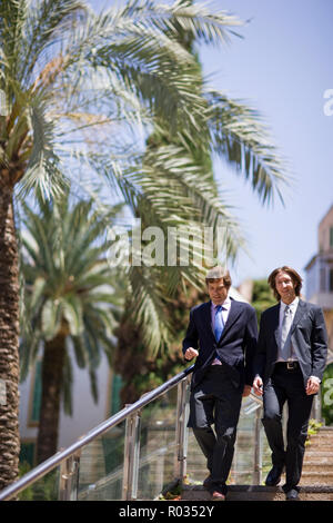 Two businessmen walking down steps in the city. Stock Photo