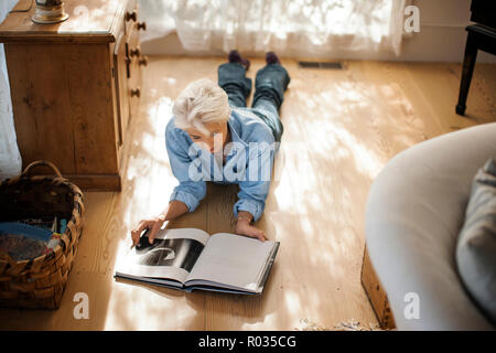 Mature woman relaxing with a book. Stock Photo