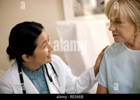 Female doctor consulting with a patient after a medical examination in her office. Stock Photo