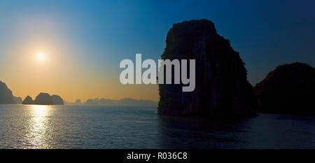 Sunset reflected on sea with silhouette of islands. Stock Photo