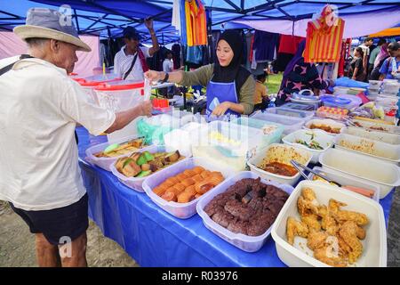 Tamparuli Sabah Malaysia - Aug 8, 2018 : Street food vendor selling cake at open market stall. Street eatery is popular among local and tourist. Stock Photo