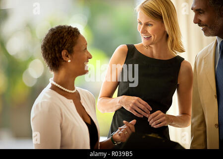 Three business colleagues talking together. Stock Photo