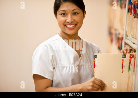 Portrait of nurse holding the folder in hospital office. Stock Photo