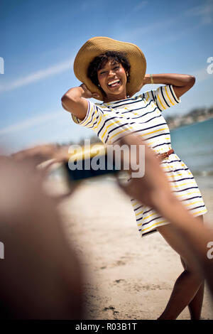 Couple taking pictures at beach. Stock Photo