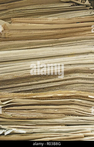 Stack of the old yellowed newspapers close up Stock Photo