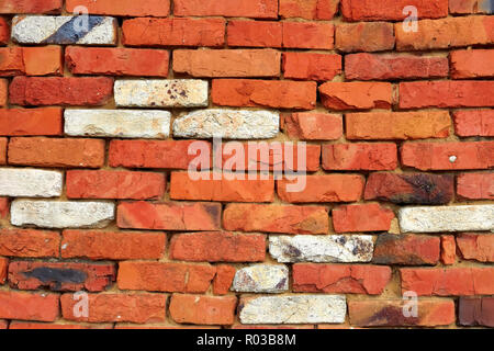 Fragment of a wall of red brick with a few bricks of white refractory silica brick Stock Photo