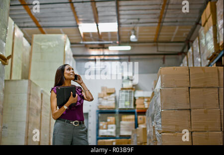Woman working in warehouse. Stock Photo