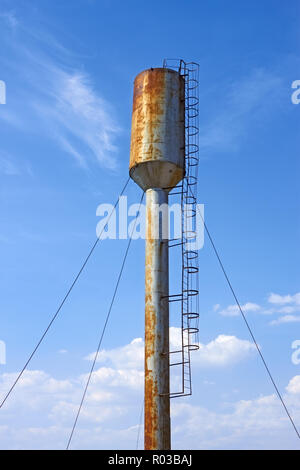 Large old metal water tower on the background of blue sky Stock Photo