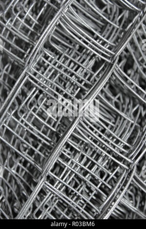 Steel mesh with water drops composed in multiple layers close-up Stock Photo