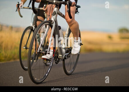 Mature couple cycling along a country road. Stock Photo