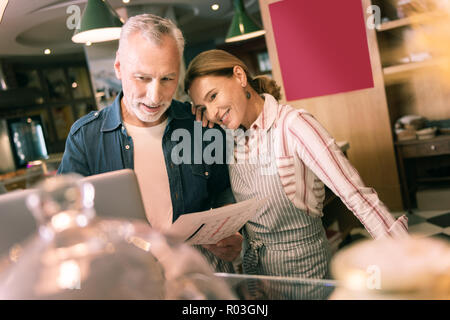 Happy woman leaning on shoulder of her smart successful businessman Stock Photo