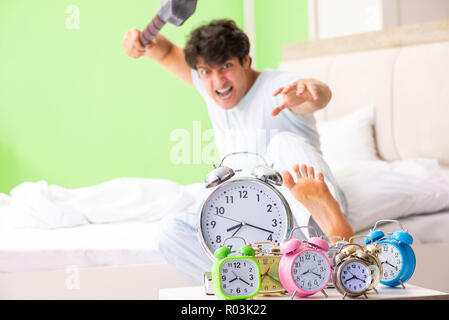 Young man having trouble waking up in early morning Stock Photo