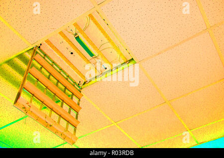 repair and installation of fluorescent lamp equipment in the office. abstact view Stock Photo
