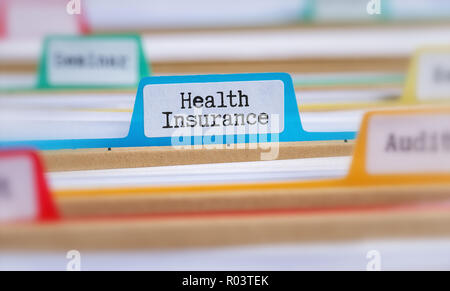 File folders with a tab labeled Health Insurance Stock Photo