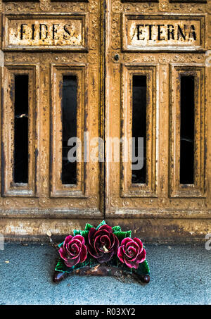 fides eterna, door of a gravesite and ceramic floral wreath Stock Photo