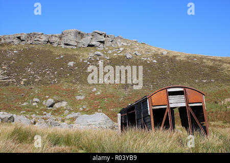 Old railway wagon on hillside on Birkdale Common at the top of Swaledale, North Yorkshire, UK. Wagon has been used for storage but is now in decaying. Stock Photo