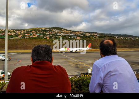 Funchal/Maderia - Portugal - 10/13/18 - Men watching the planes in Funchal airport Stock Photo