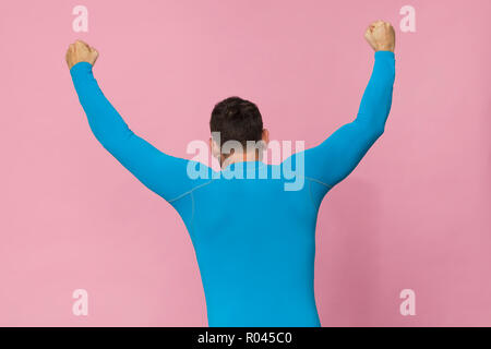 Tall man back portrait in blue sport shirt, isolated on pink Stock Photo