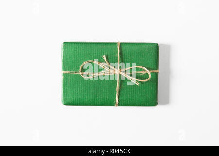 Green presents in gift box on white background. Flat lay, top view Stock Photo
