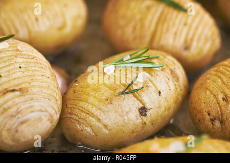 Homemade cheesy Hasselback potatoes. Vegetarian food Stock Photo