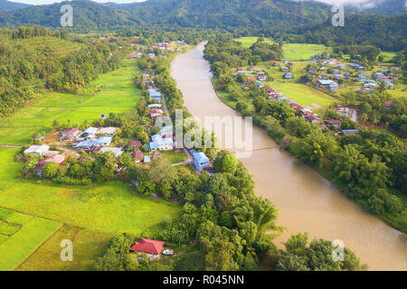 Morning landscape of village with river and green paddy field at Kiulu Sabah Malaysia Borneo. Stock Photo