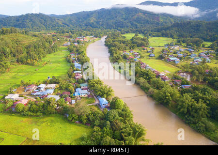 Morning landscape of village with river and green paddy field at Kiulu Sabah Malaysia Borneo. Stock Photo