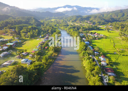 Morning landscape of village with river and green paddy field at Kiulu Sabah Malaysia Borneo. Stock Photo