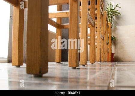 A row of wooden bar stools in a bistro Stock Photo