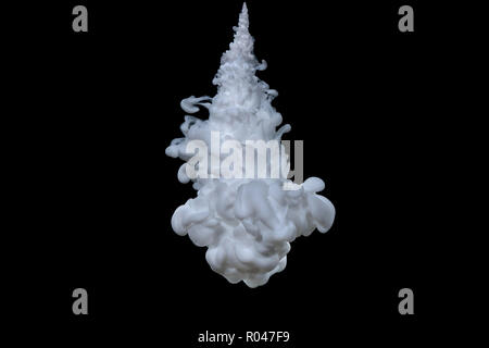 Explosion of white acrylic paint in water on black background. Stock Photo