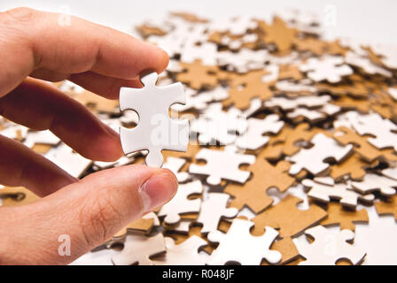 hand holding single puzzle piece Stock Photo
