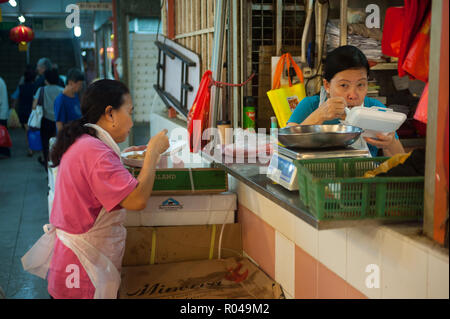 Singapore, Republic of Singapore, Two eating meat saleswomen in Chinatown Stock Photo