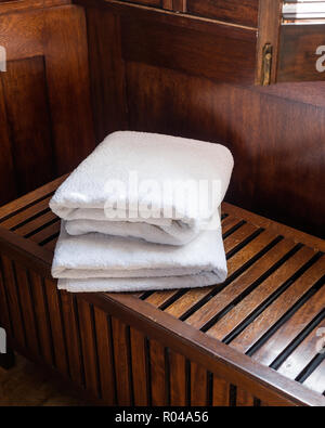 Towels on wooden bench Stock Photo