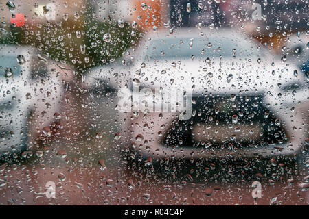 View at parked cars through window glass covered with raindrops Stock Photo